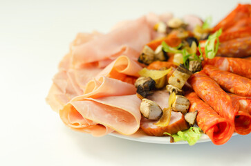 A cold plate prepared for the party with sliced chorizo, ham and sausages
