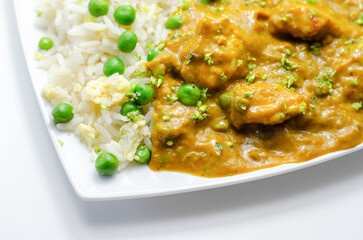 Chicken curry with egg fried rice, chicken breast pieces in a mildly spiced coconut curry sauce with fried rice with peas and egg