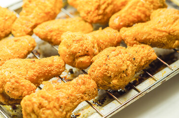 Southern crispy battered fried chicken wings, deep-fried chicken wings on the metal tray