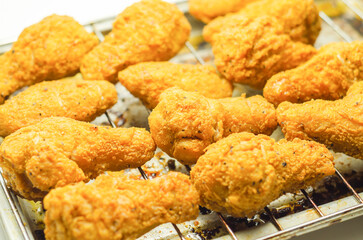 Southern crispy battered fried chicken wings, deep-fried chicken wings on the metal tray