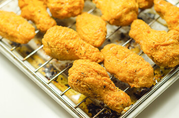 Southern crispy battered fried chicken wings, deep-fried chicken wings on the metal tray