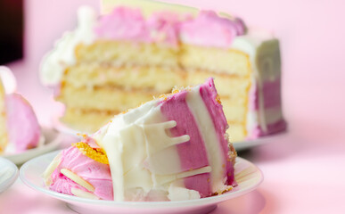 Moist madeira sponge, layered with plum and raspberry jam, coated and topped with white and pink colour frostings, decorated with white chocolate decorations