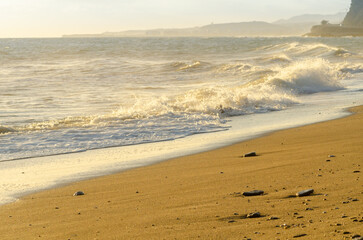 View on the seawater affecting the sand on the beach, sea waves flowing  calmly at the sand