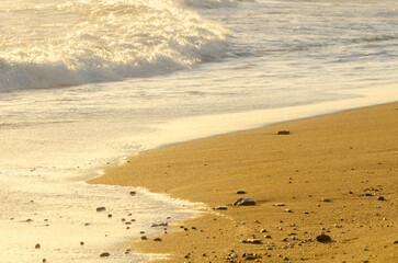 View on the seawater affecting the sand on the beach, sea waves flowing  calmly at the sand