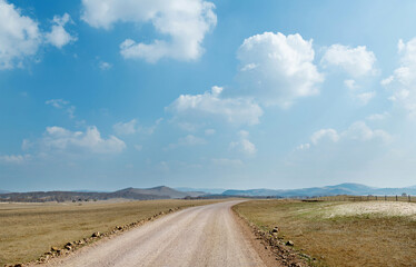 A dirt road through the field