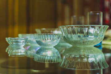 Three glass bowels are kept according to their size on a glass top .
