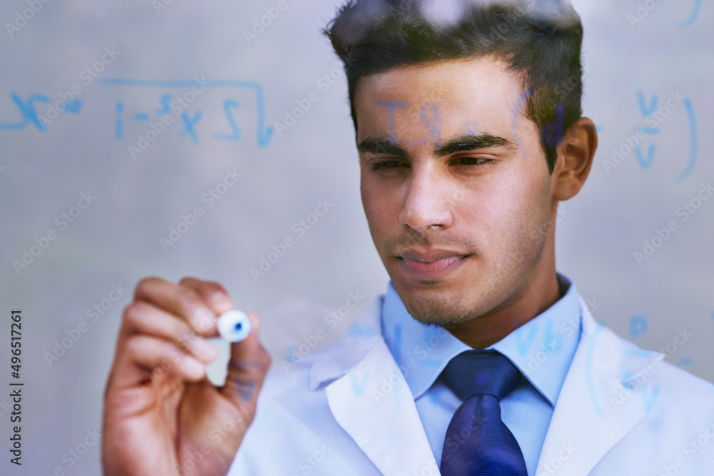 Poster formulating a new hypothesiss. shot of a scientist writing formulas on a glass wall.