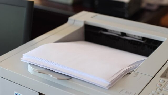 Office laser printer printing on A4 paper. The process of printing on paper using a printer.