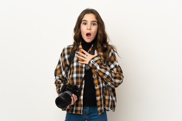 Little photographer girl isolated on background surprised and shocked while looking right