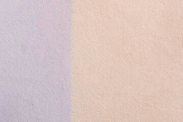 The colored wall is two colors: light warm cream or peach and lilac bright abstract paint background design