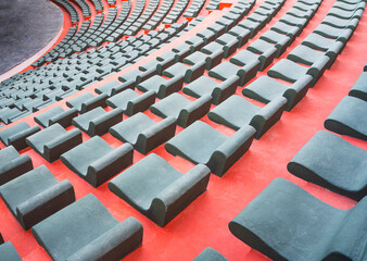 rows of empty green chairs on the red carpet in the outdoor entertainment hall during the summer holidays