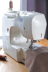 Sewing. Recycling Made by hand from home.sewing machine and the project quarantine, lockdown.Hobby,meditation,zero waste,recycling.Girl sews clothes  home on sewing machine, ecology,sewing backround