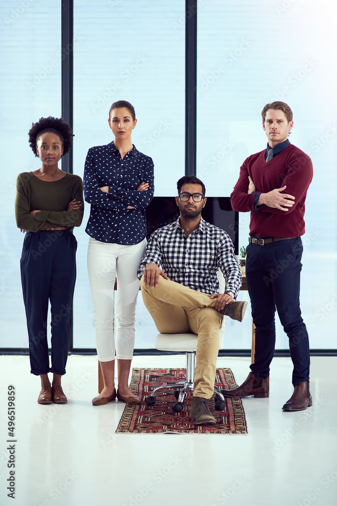 Poster success is theirs for the taking. portrait of a group young designers at a work station in front of 