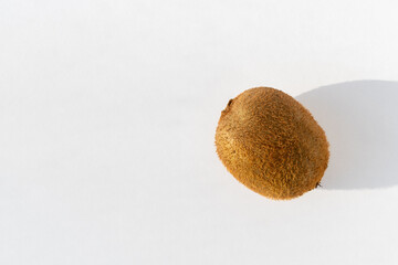 Ripe unpeeled kiwi fruit on a white background, copy space. Kiwi is a natural dietary product, a...