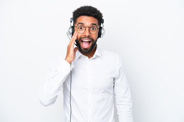 Telemarketer Brazilian man working with a headset isolated on white background with surprise and shocked facial expression