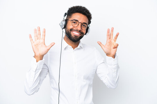 Telemarketer Brazilian man working with a headset isolated on white background counting nine with fingers