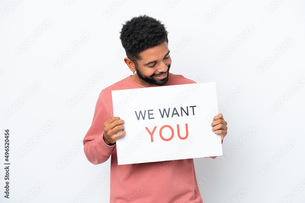 Wall mural young brazilian man isolated on white background holding we want you board