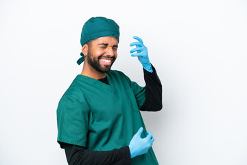Surgeon Brazilian man in green uniform isolated on white background making guitar gesture