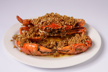 Roasted crab maritess crab wokkin in a dish top view on grey background singapore food