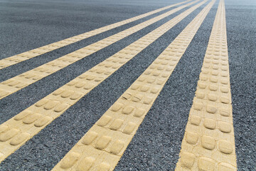 Yellow lines with bump on the road
