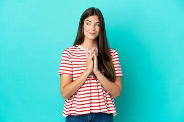 Young Brazilian woman isolated on blue background scheming something