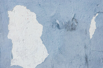 Blue peeling paint plaster with old weathered concrete obsolete wall cement worn texture messy...
