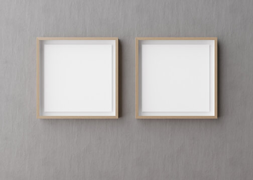 Two blank square picture frames hanging on gray concrete wall. Template, mock up for your picture or poster. Copy space. 3D rendering.