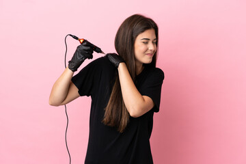 Tattoo artist woman isolated on pink background suffering from pain in shoulder for having made an effort