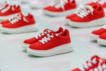 Group of children sports shoes in the store