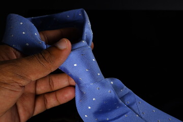hand with tie with tie knot