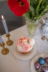 Festive Easter cakes with white icing and sugar decor on a table decorated in spring style