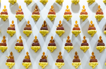 Group of Buddha statues on the wall