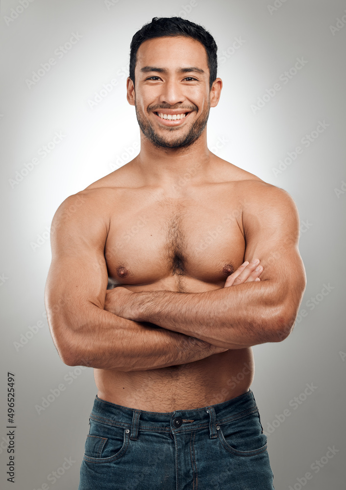 Poster get up and work for the body you want. shot of a handsome young man standing alone in the studio pos