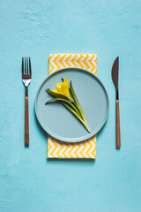 Spring table setting with yellow flower