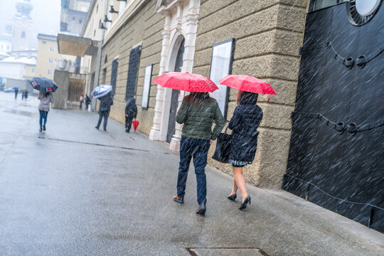 Person Walking In The Rain City Of Salzburg Festival Hall