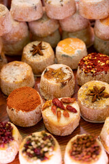 Variety of French soft goat cheese with different toppings, indian, curry, pepper, spicy
