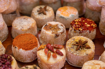 Variety of French soft goat cheese with different toppings, indian, curry, pepper, spicy
