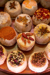 Variety of French soft goat cheese with different toppings, indian, curry, pepper, spicy