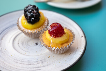 Mini fruit italian cupcakes with fresh berries on board
