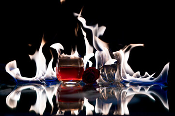 Alcoholic drink Whiskey with a glass on its side on a reflective surface with beautiful white...