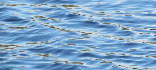Light blue shining rippled water texture as a background