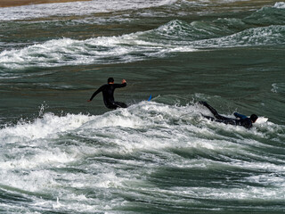 a surfer surf a wave in italy