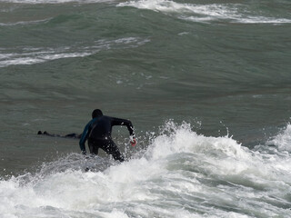 a surfer surf a wave in italy