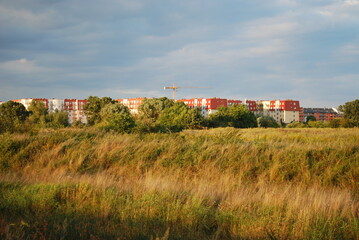 houses on the other side of the grassy river © TK_Office