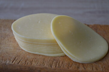 Sliced Cheese on wooden background