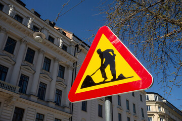 Men at work traffic sign with yellow colour in Sweden