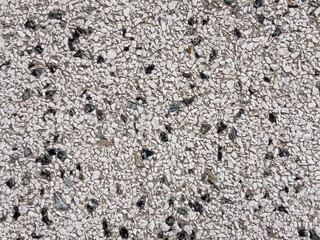 Modern stony plaster with small stones on an exterior wall of a house