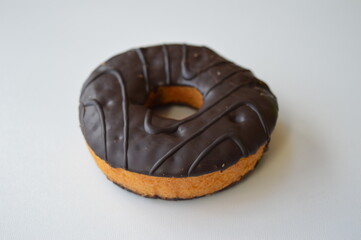 Delicious donut topped with chocolate on a white background