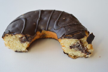 Delicious donut topped with chocolate on a white background