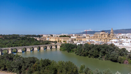 Aerial view of the old medieval city of Cordoba in Andalusia, Spain during a sunny day. Medieval mosque cathedral and Roman bridge over Guadalquivir river, UNESCO World Heritage site. Tourism.
